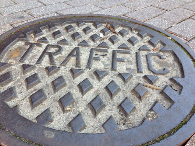 Sewer hole cover labeled Traffic