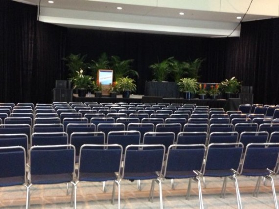 Room setup with hundreds of chairs and a stage