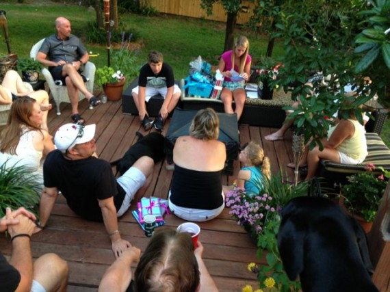 High School graduate the day before is surrounded by small, and loving Family