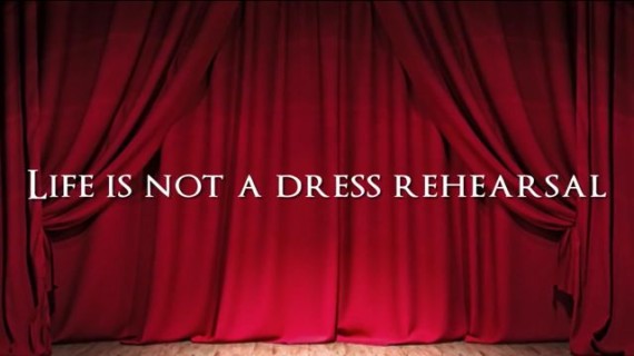 Red stage curtain with Midlife Celebration tagline