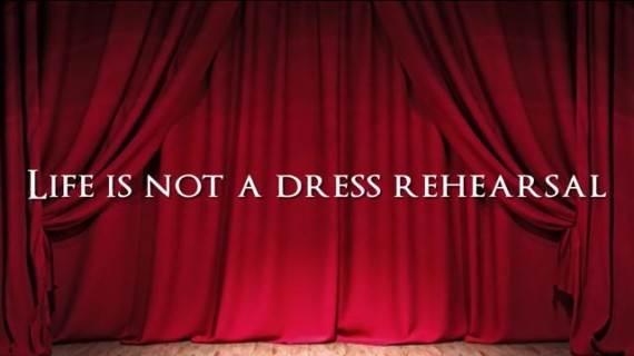 Red stage curtain with Midlife Celebration tagline