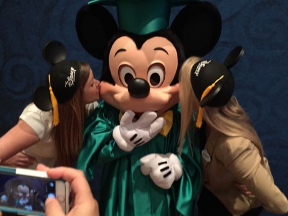 Mickey Mouse being kissed by two women