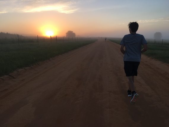 runner in silhouette of sunrise 