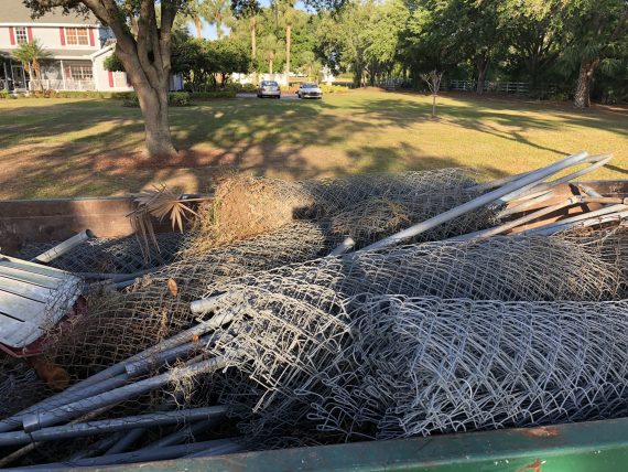 dumpster full of chain link fence debris