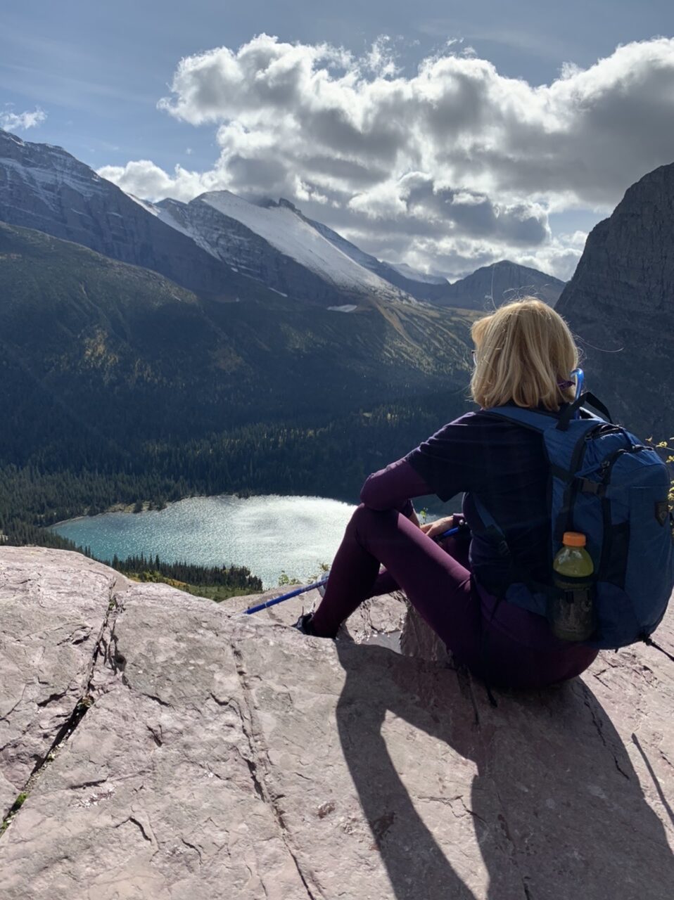 Woman sitting in rock in mountains