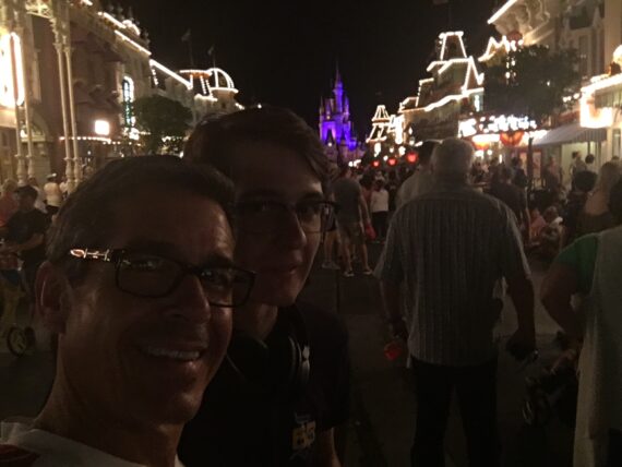 crowded main Disney Main Street at night