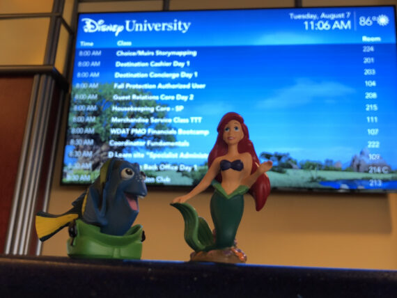 Disney toy characters in front of lobby LCD screen