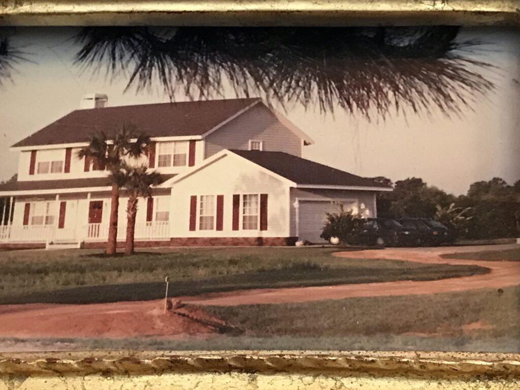 two story home with long clay driveway