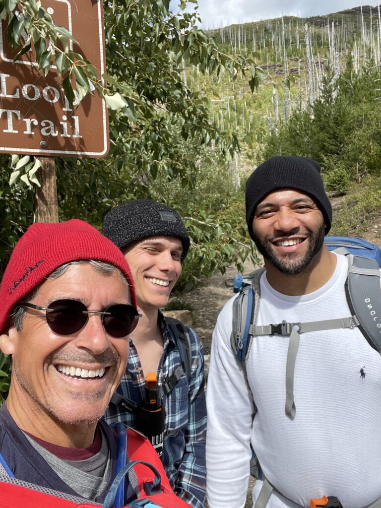 Three men at hiking trailhead
