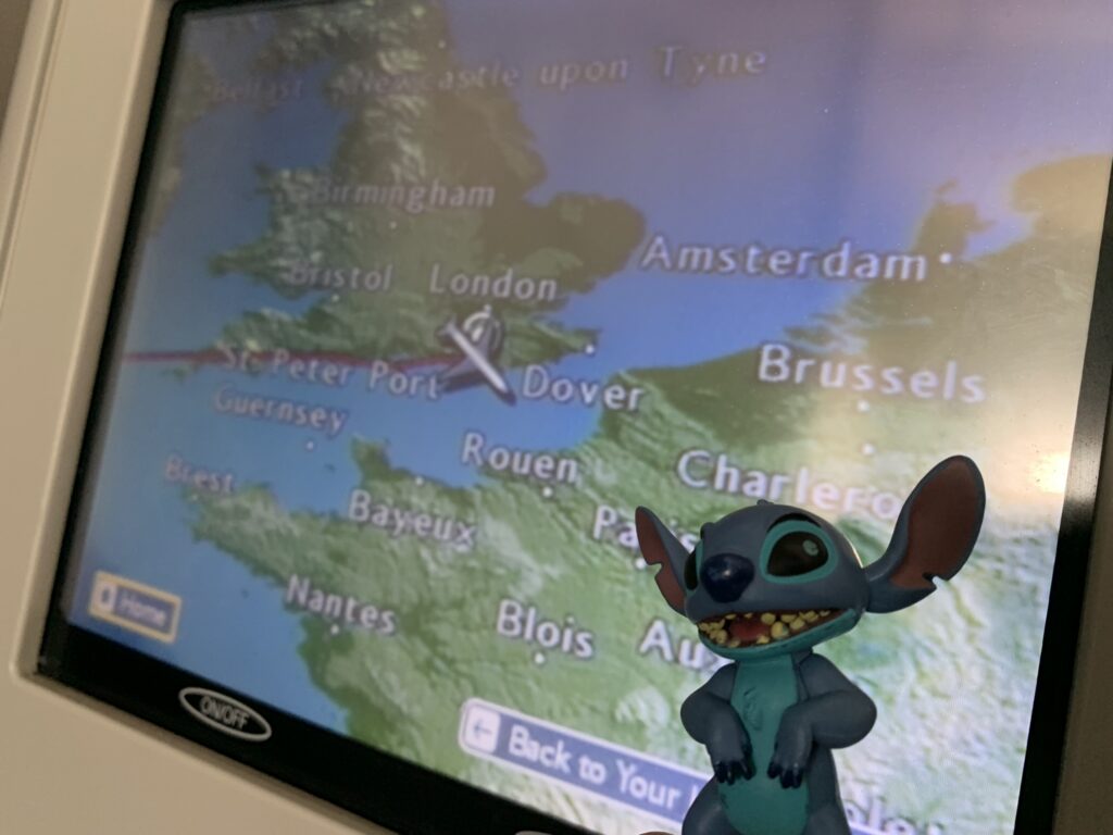 Toy Stitch character in front of setback flight map