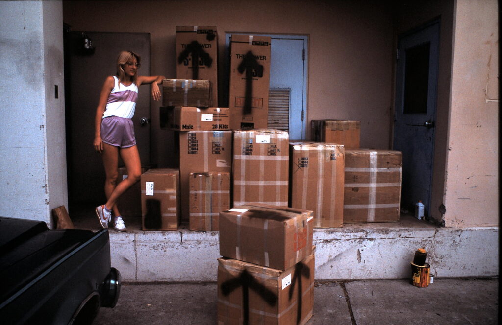 woman on loading dock piled high with boxes