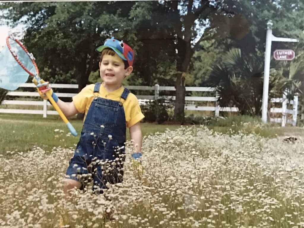 child walking through a bed of wildflowers