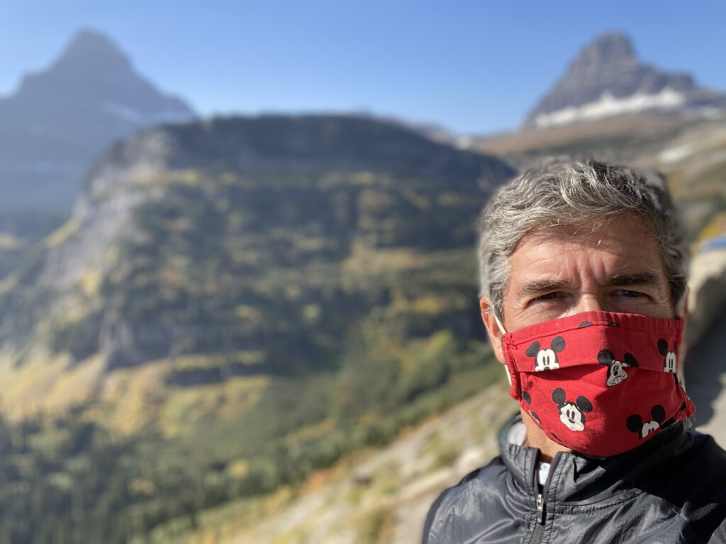 man in the mountains wearing a mask