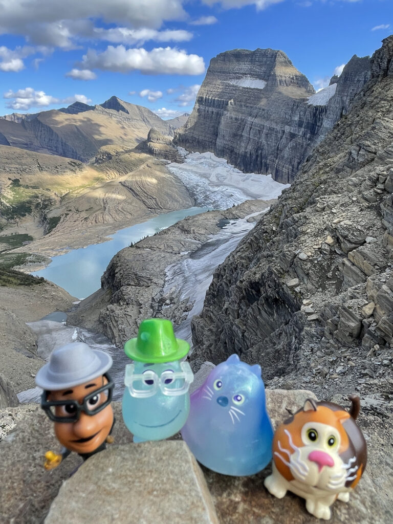 Small Pixar toy characters in mountains